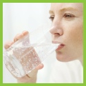 woman drinking from a glass of water