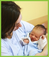 mother looking at newborn