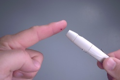 Doing a finger prick blood test for diabetes